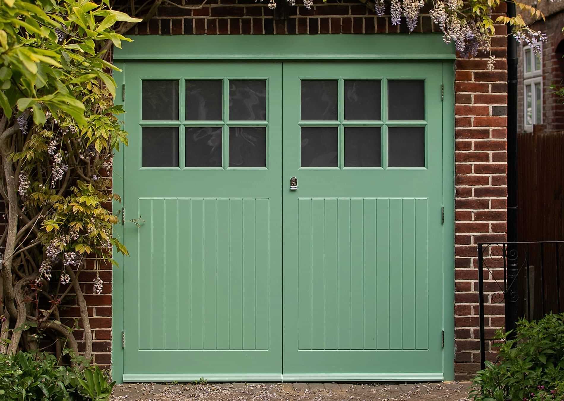 painted bespoke garage doors and frame. door have glass in the top part